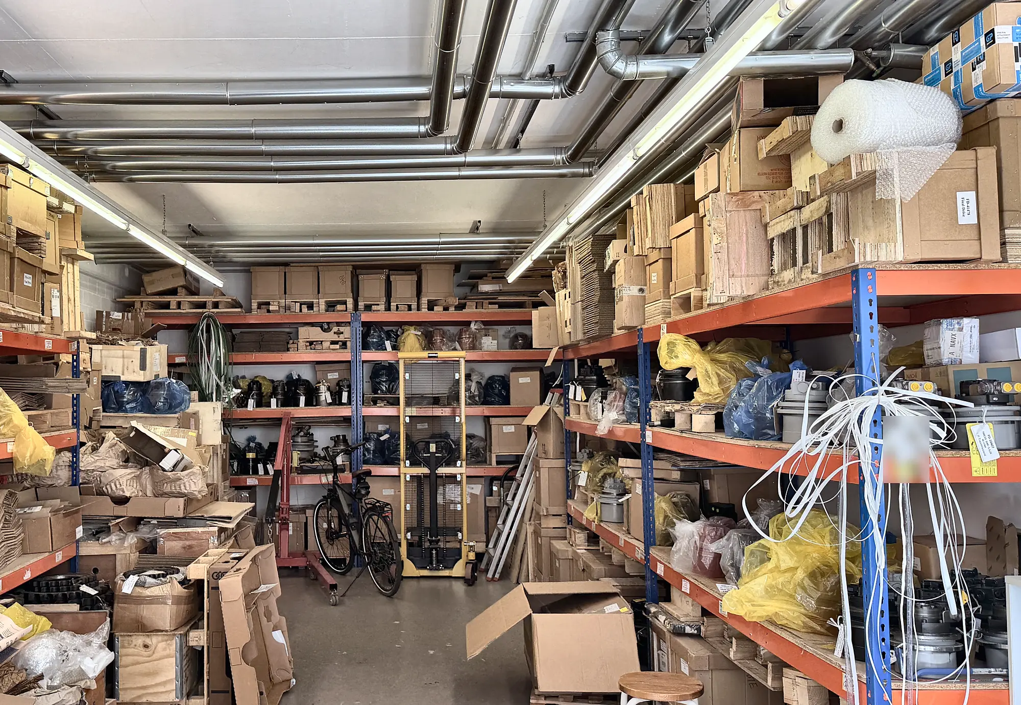 Warehouse with shelves full of final drives and shipping boxes